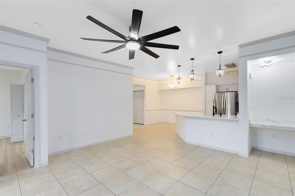 3315 Parkchester Square Boulevard, Unit 102 Orlando, FL 32835 - Photo 11 of 37 a view of a living room with a ceiling fan