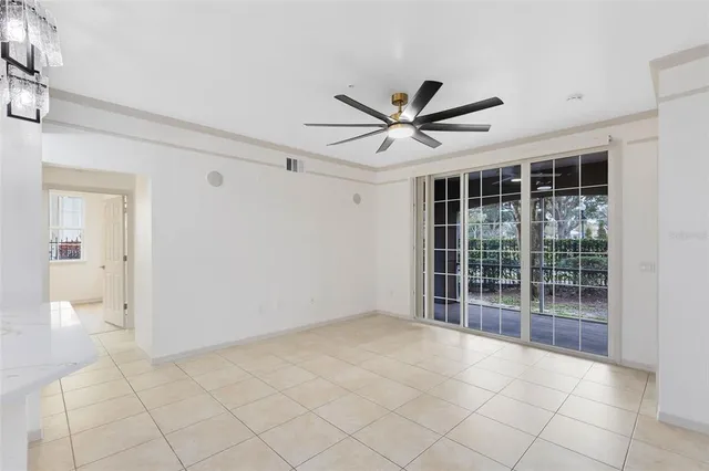 en empty room with white walls and windows