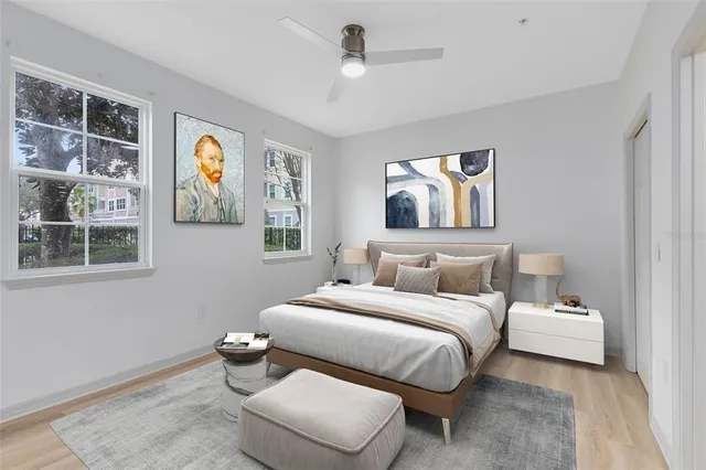 a bedroom with a bed and painting on the wall