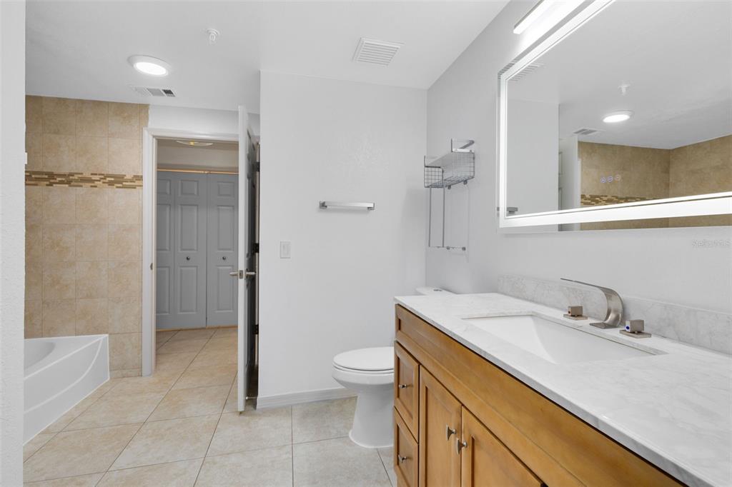 3315 Parkchester Square Boulevard, Unit 102 Orlando, FL 32835 - Photo 17 of 37 a bathroom with a sink a toilet and shower