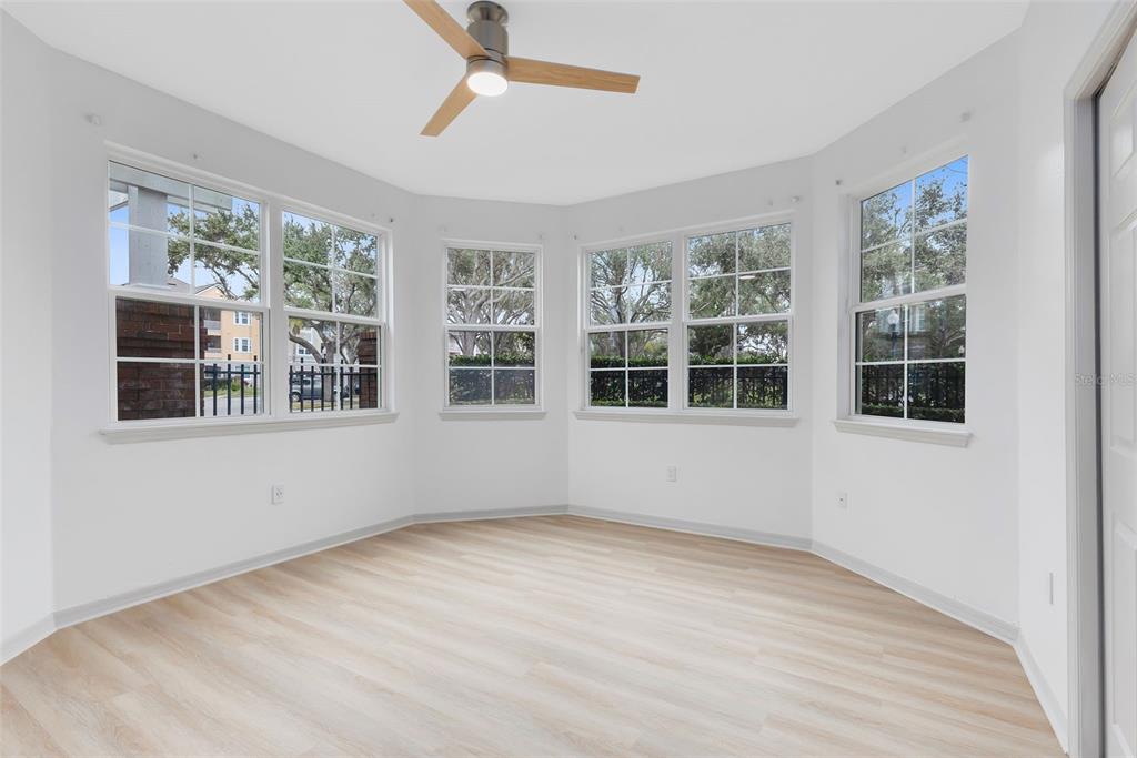 3315 Parkchester Square Boulevard, Unit 102 Orlando, FL 32835 - Photo 19 of 37 a view of empty room with wooden floor and fan