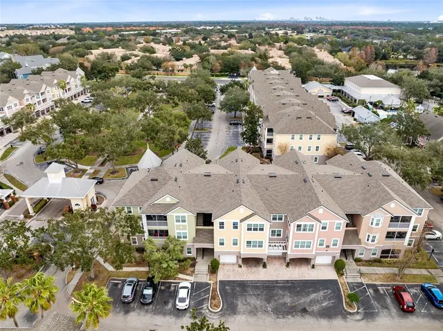 an aerial view of residential houses with outdoor space and parking