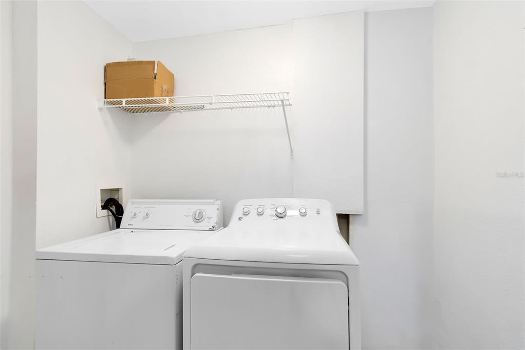 3315 Parkchester Square Boulevard, Unit 102 Orlando, FL 32835 - Photo 27 of 37 a utility room with dryer and washer