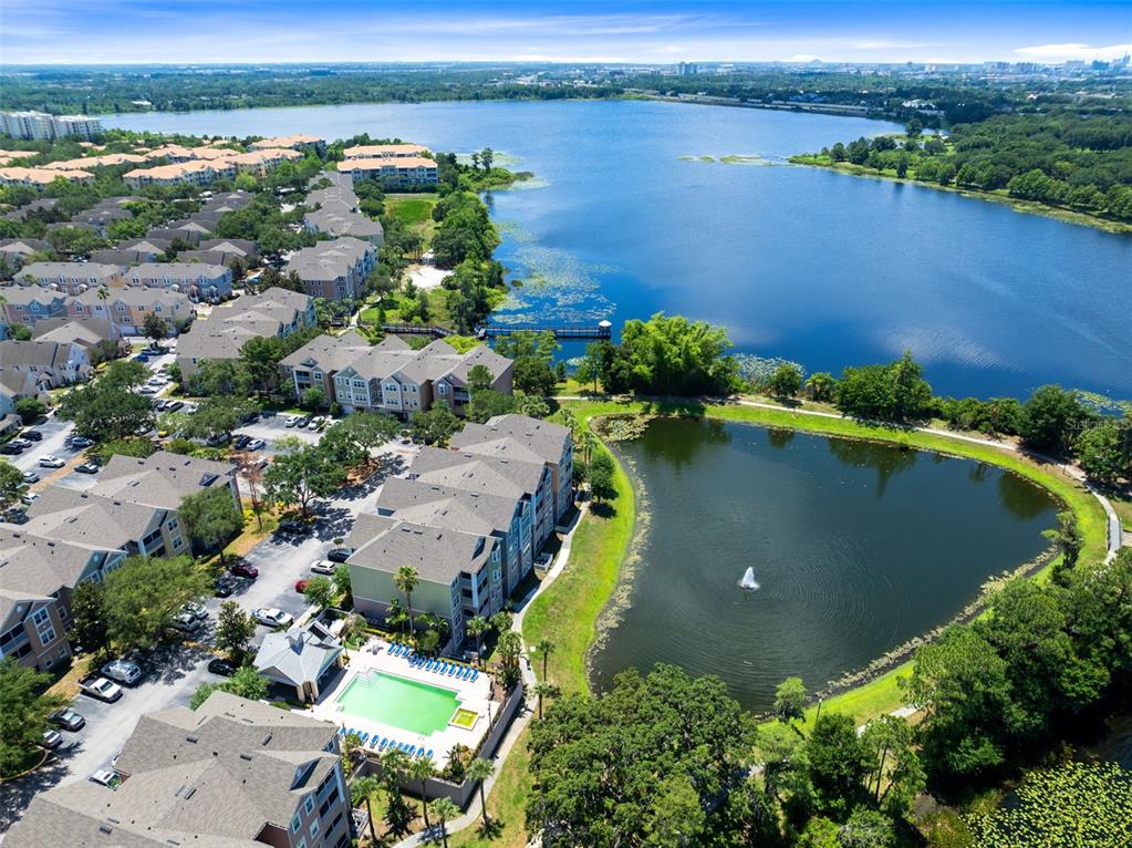 3315 Parkchester Square Boulevard, Unit 102 Orlando, FL 32835 - Photo 34 of 37 an aerial view of a house with a lake view