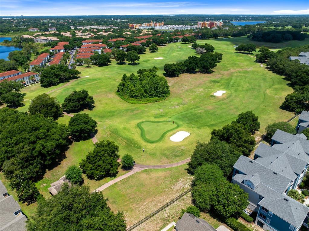 3315 Parkchester Square Boulevard, Unit 102 Orlando, FL 32835 - Photo 35 of 37 an aerial view of green landscape with trees houses and mountain view