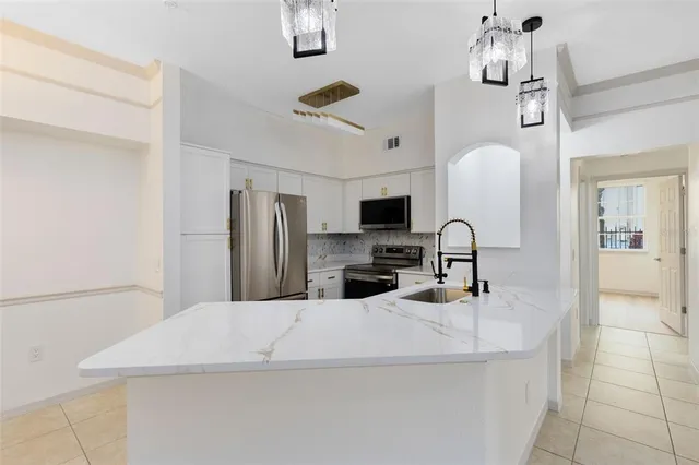 a kitchen with stainless steel appliances a microwave a sink a stove and refrigerator