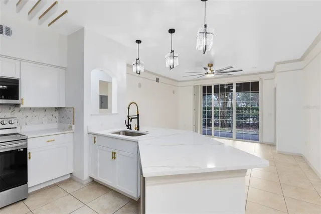 a kitchen with a sink stove and cabinets