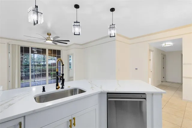 a view of a sink and dishwasher with wooden floor