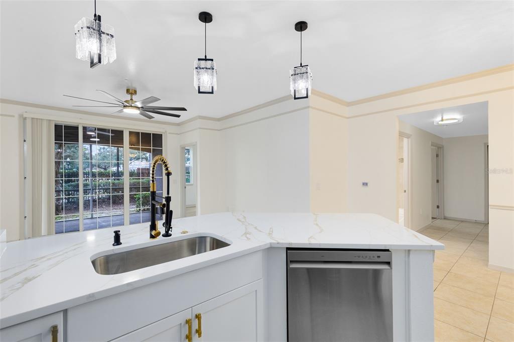 3315 Parkchester Square Boulevard, Unit 102 Orlando, FL 32835 - Photo 8 of 37 a view of a sink and dishwasher with wooden floor