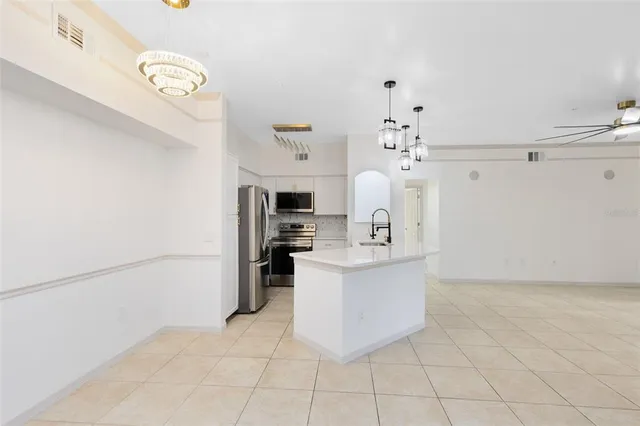 a view of kitchen with furniture and refrigerator