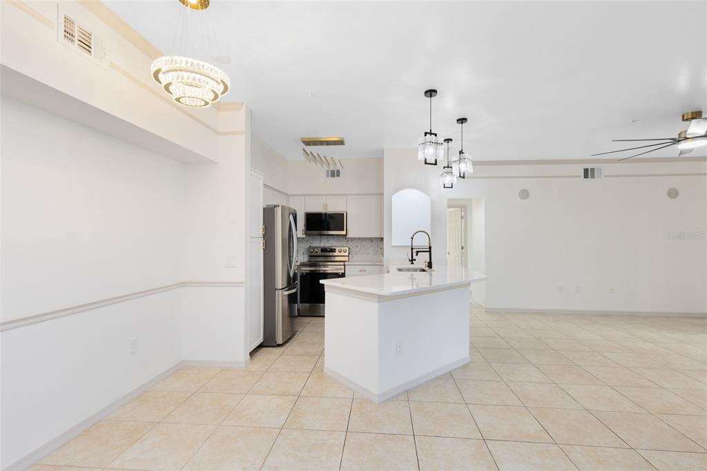 3315 Parkchester Square Boulevard, Unit 102 Orlando, FL 32835 - Photo 9 of 37 a view of kitchen with furniture and refrigerator