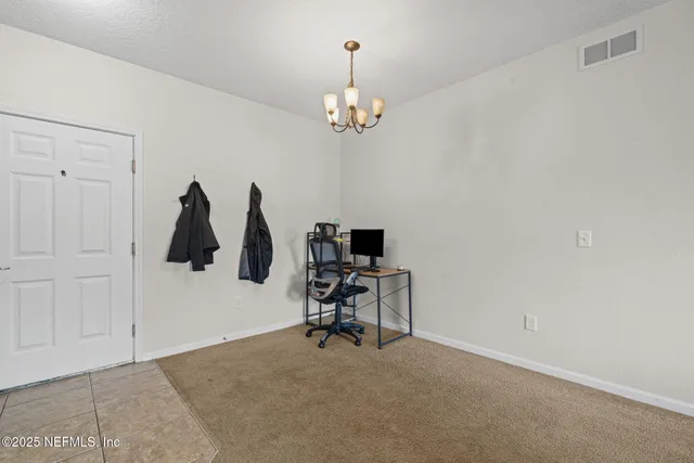 a view of a chandelier and entryway