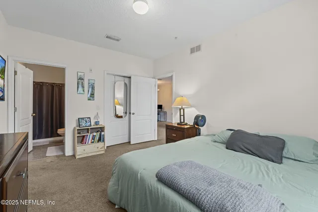 a bedroom with a bed and dresser