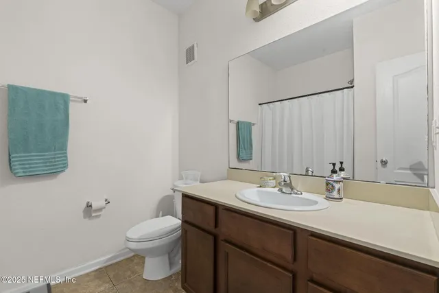 a bathroom with a sink a toilet and mirror