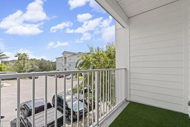 a view of a balcony with chairs