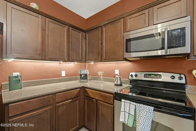 a kitchen with a sink stove and microwave
