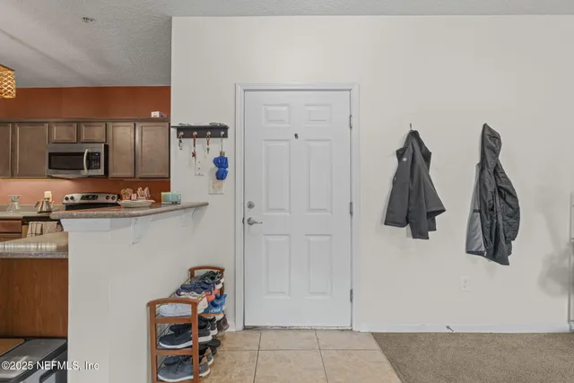 a view of walk in closet with clothes