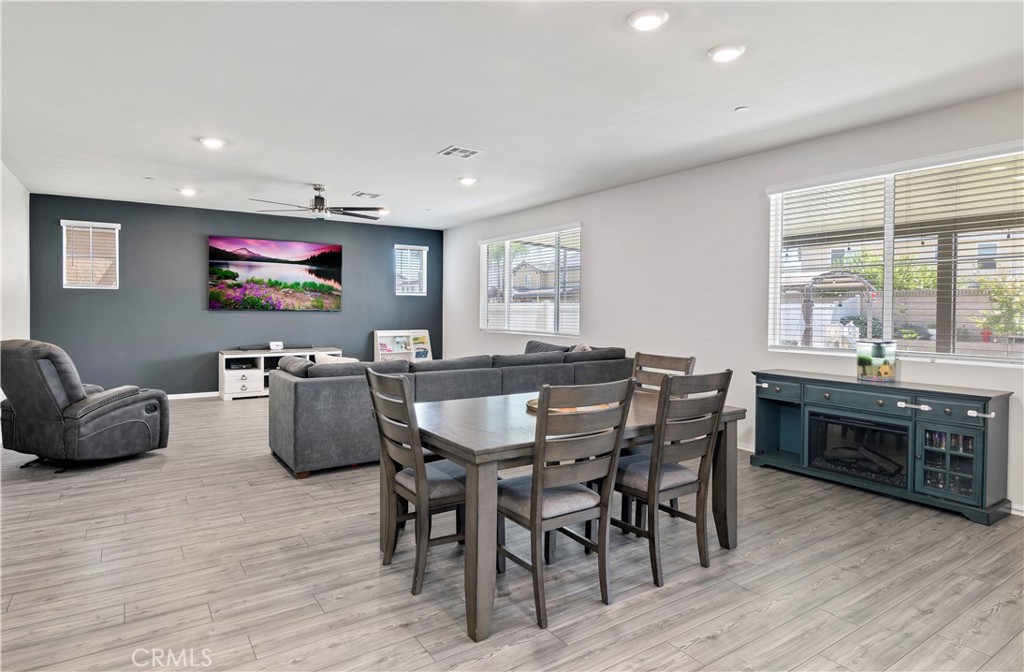 32942 Forgecroft Street Menifee, CA 92584 - Photo 15 of 44 a view of a dining room with furniture window and wooden floor