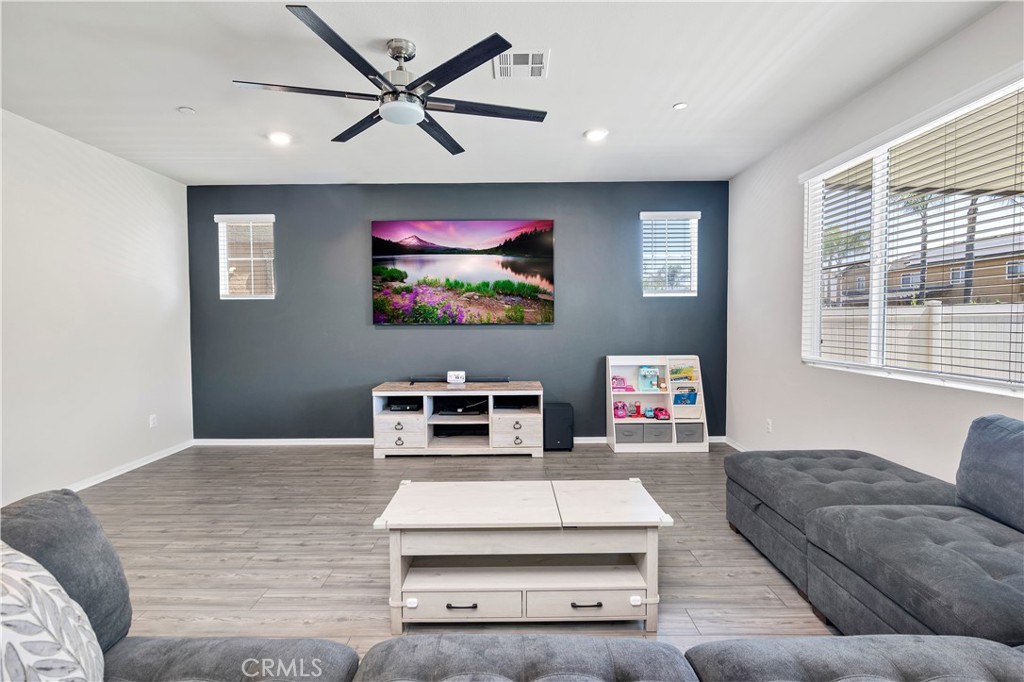 32942 Forgecroft Street Menifee, CA 92584 - Photo 16 of 44 a living room with furniture and a flat screen tv