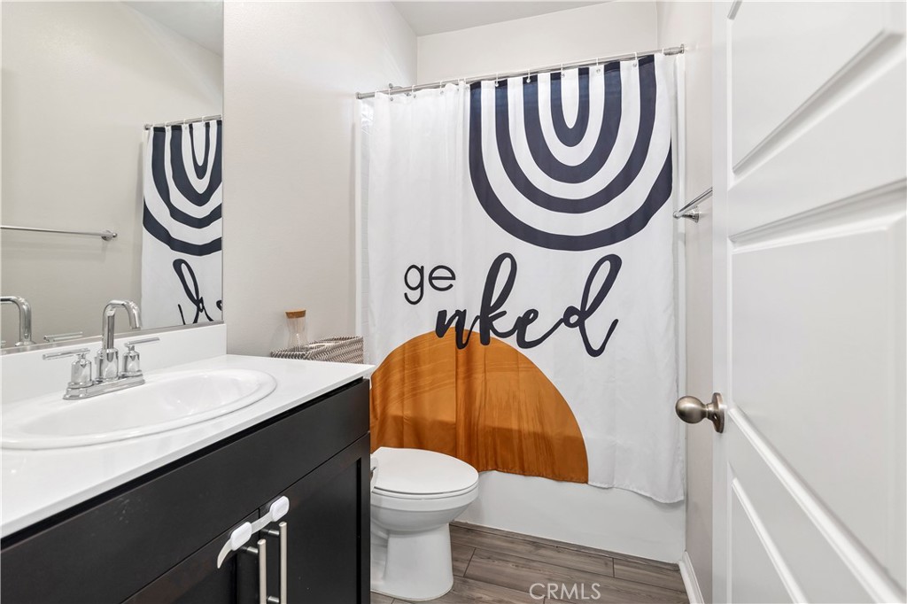 32942 Forgecroft Street Menifee, CA 92584 - Photo 19 of 44 a bathroom with a sink a mirror and a toilet