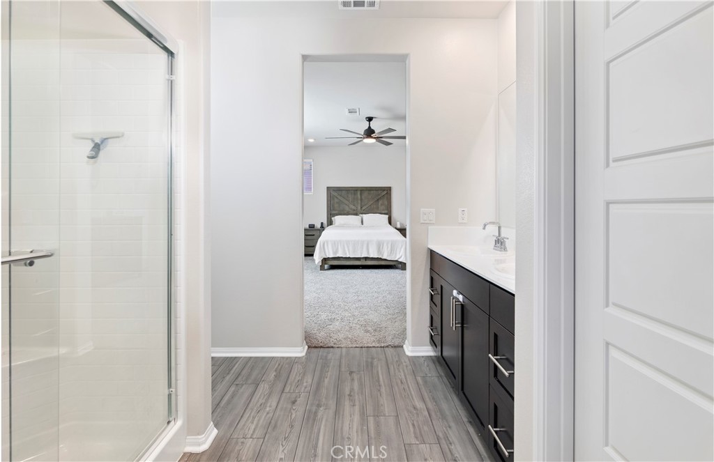 32942 Forgecroft Street Menifee, CA 92584 - Photo 30 of 44 a en suite bathroom with a sink and mirror