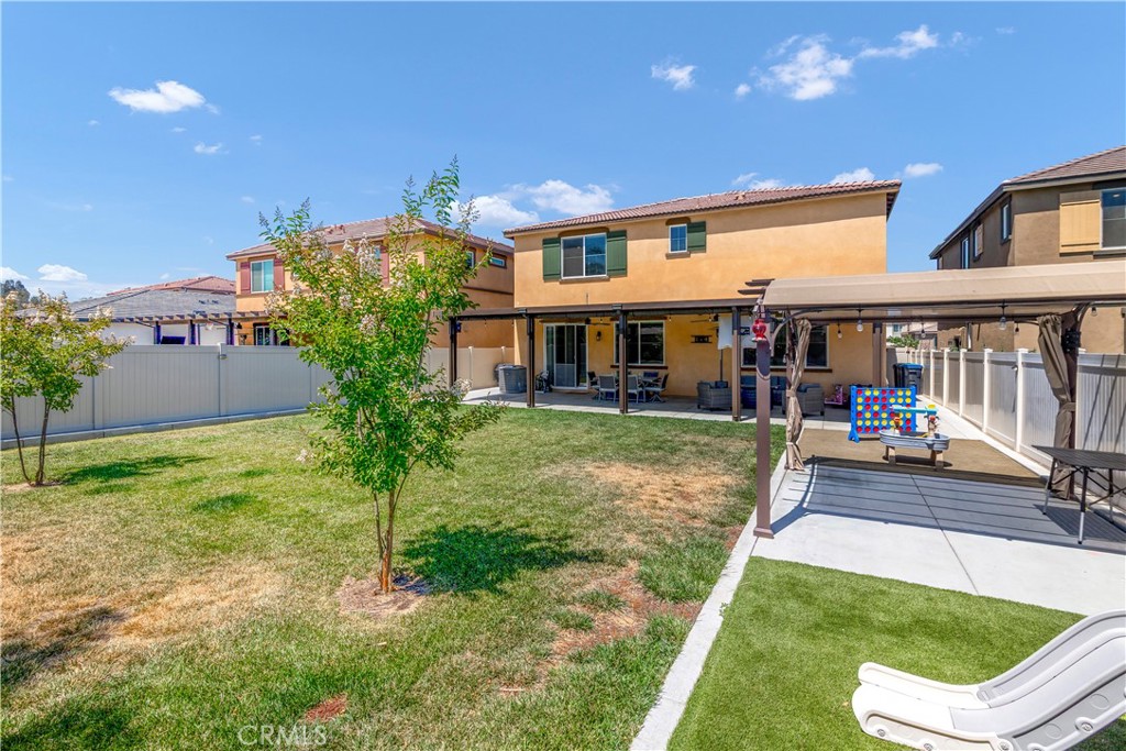 32942 Forgecroft Street Menifee, CA 92584 - Photo 36 of 44 a view of a house with a yard porch and sitting area