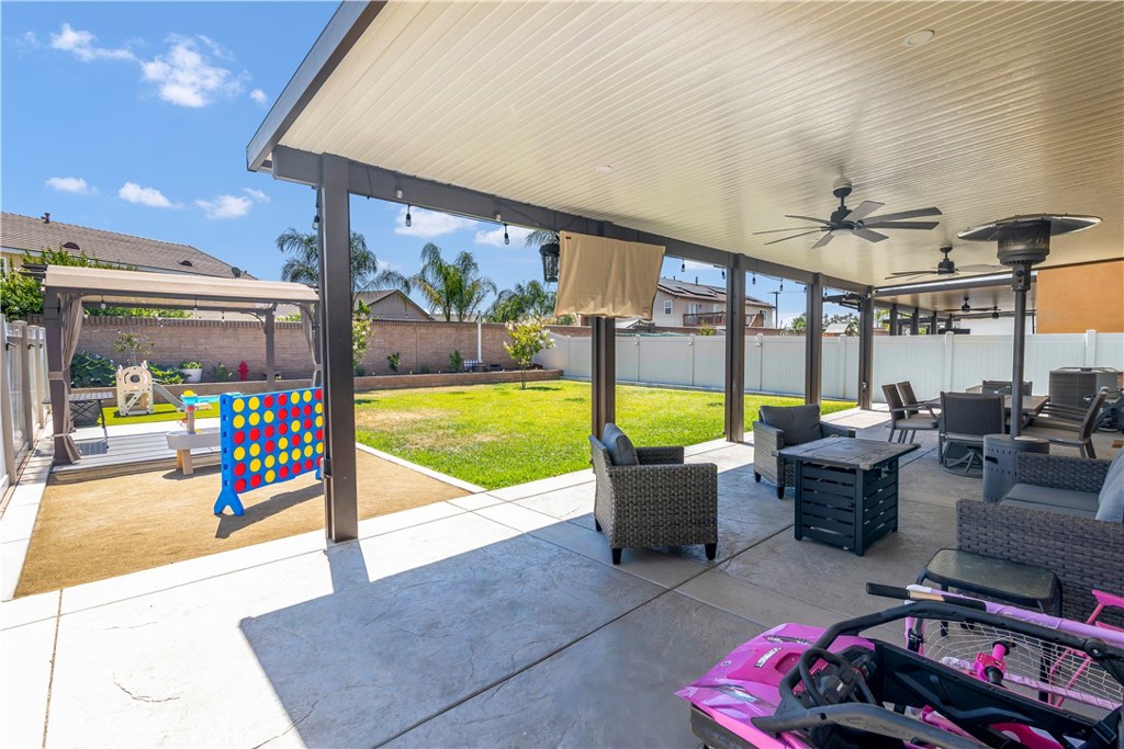 32942 Forgecroft Street Menifee, CA 92584 - Photo 37 of 44 a living room with furniture and a floor to ceiling window