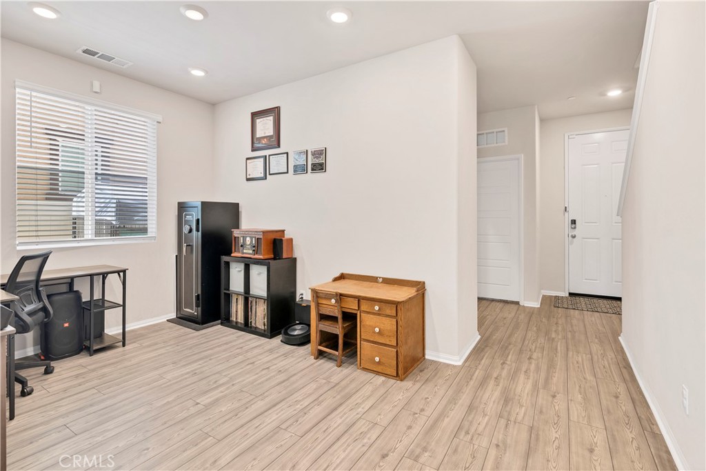 32942 Forgecroft Street Menifee, CA 92584 - Photo 6 of 44 a room with wooden floor and furniture