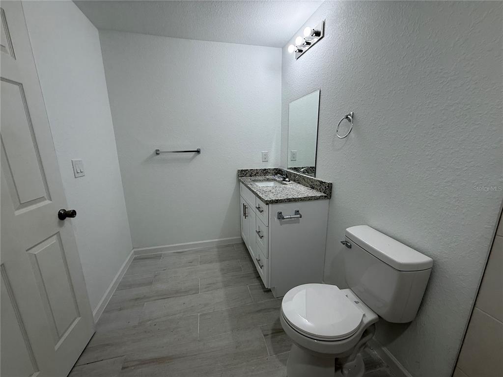 1328 Guttenburg Road North Port, FL 34288 - Photo 11 of 28 a white toilet sitting next to a bathroom sink
