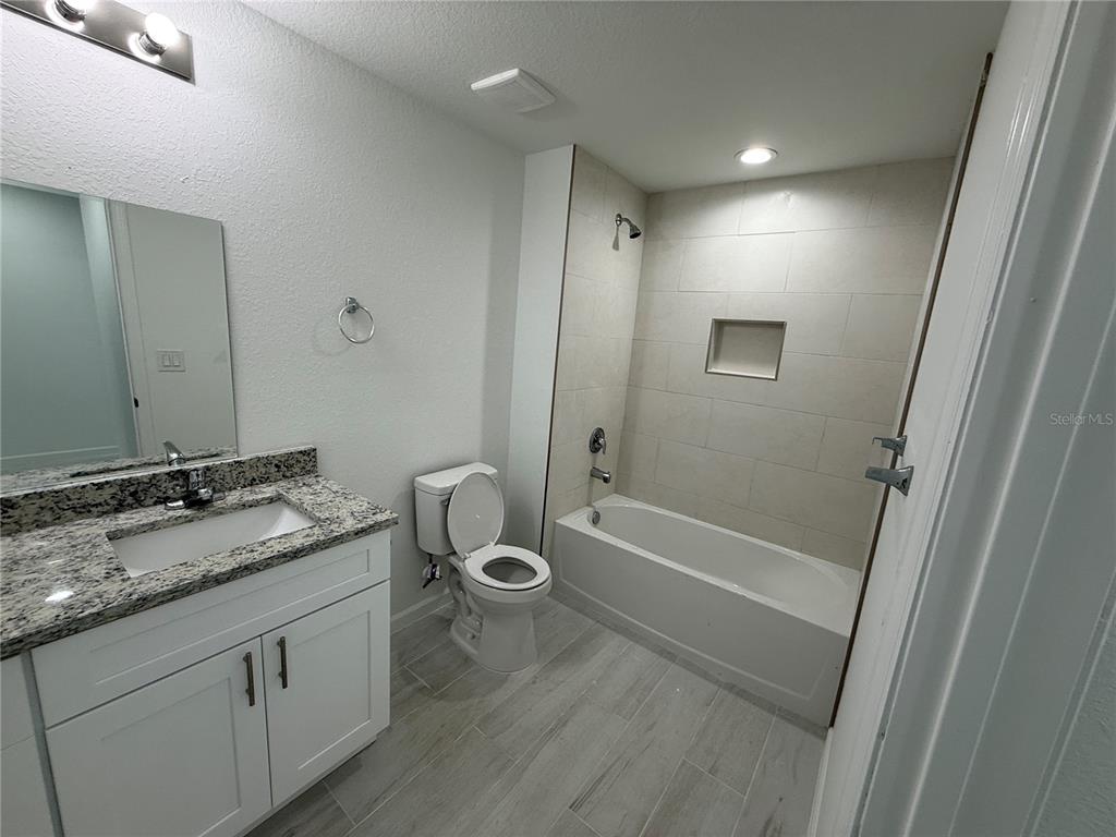 1328 Guttenburg Road North Port, FL 34288 - Photo 15 of 28 a bathroom with a granite countertop sink toilet and shower