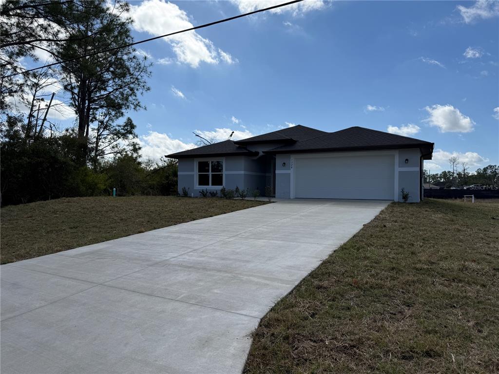 1328 Guttenburg Road North Port, FL 34288 - Photo 2 of 28 a front view of a house with a garden