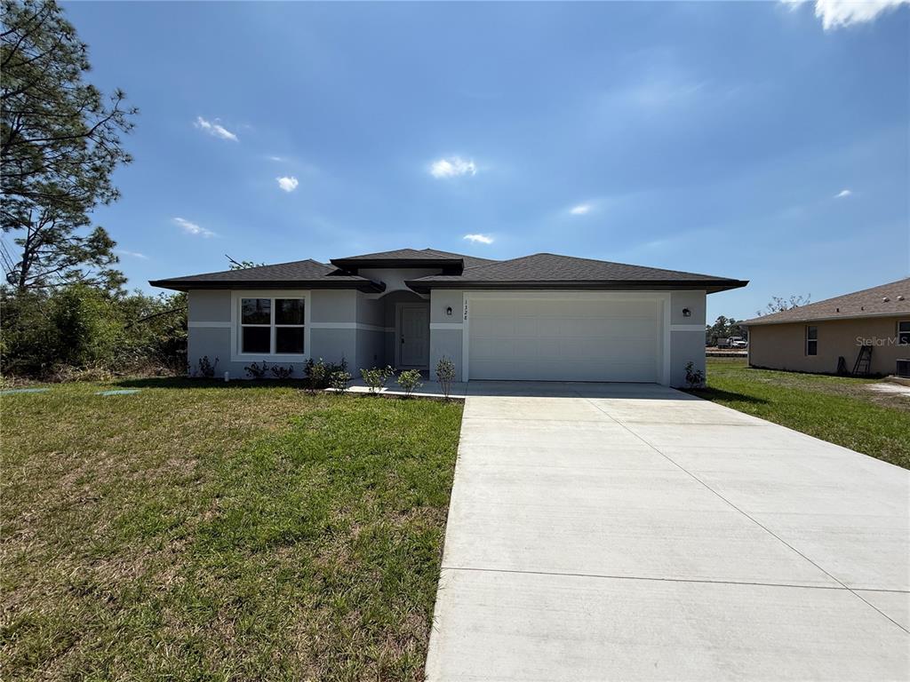 1328 Guttenburg Road North Port, FL 34288 - Photo 2 of 32 a front view of a house with a yard and a garage