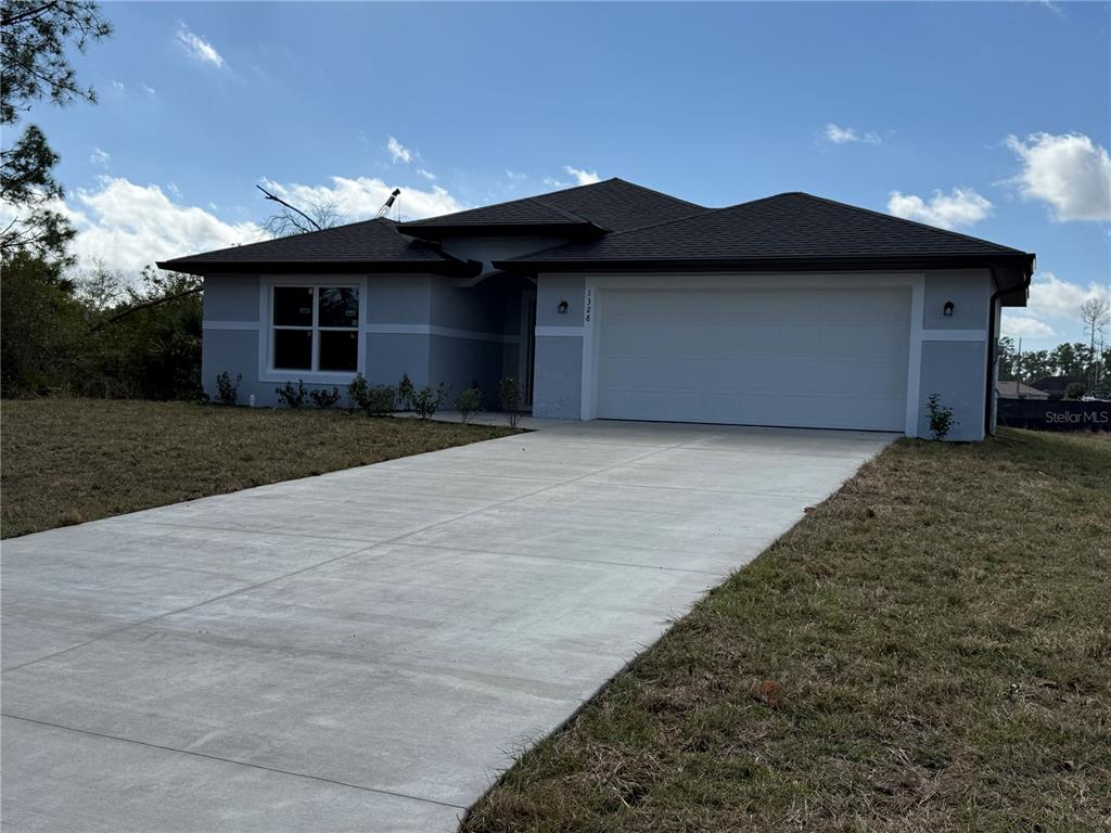 1328 Guttenburg Road North Port, FL 34288 - Photo 32 of 32 a front view of a house with a yard