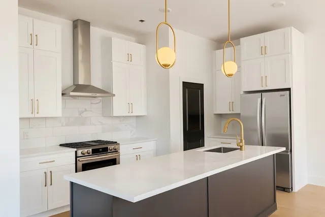 a view wooden floor and kitchen counter top space