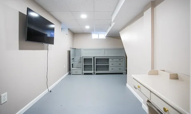 a view of a kitchen with a sink and a refrigerator