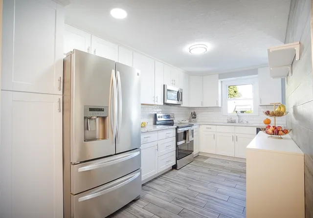 a kitchen with a refrigerator stove and sink
