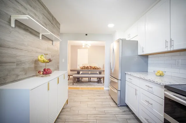 a kitchen with stainless steel appliances a sink stove and refrigerator
