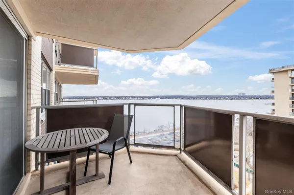 a balcony with table and chairs