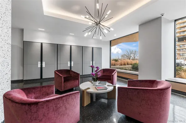 a living room with furniture a rug and a chandelier