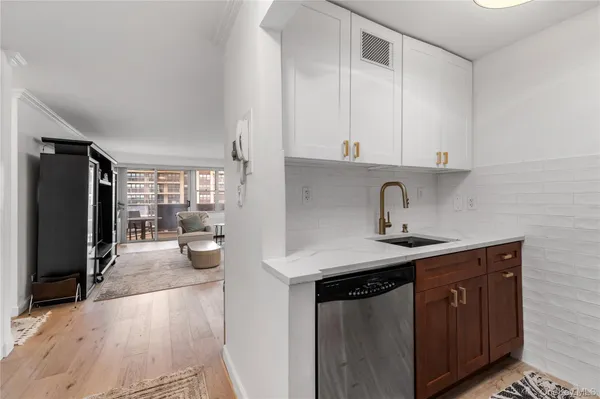 a kitchen with a sink a stove and cabinets