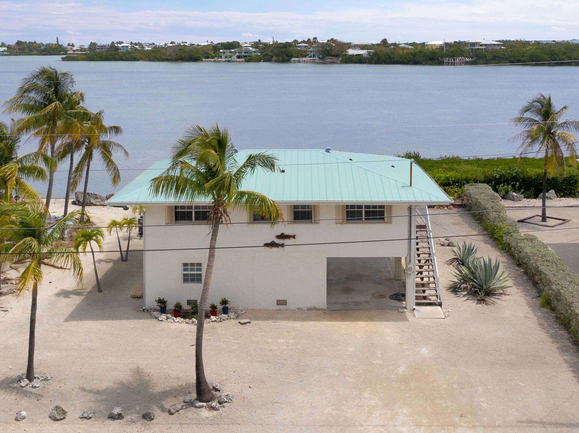 a view of a house with outdoor space and lake view