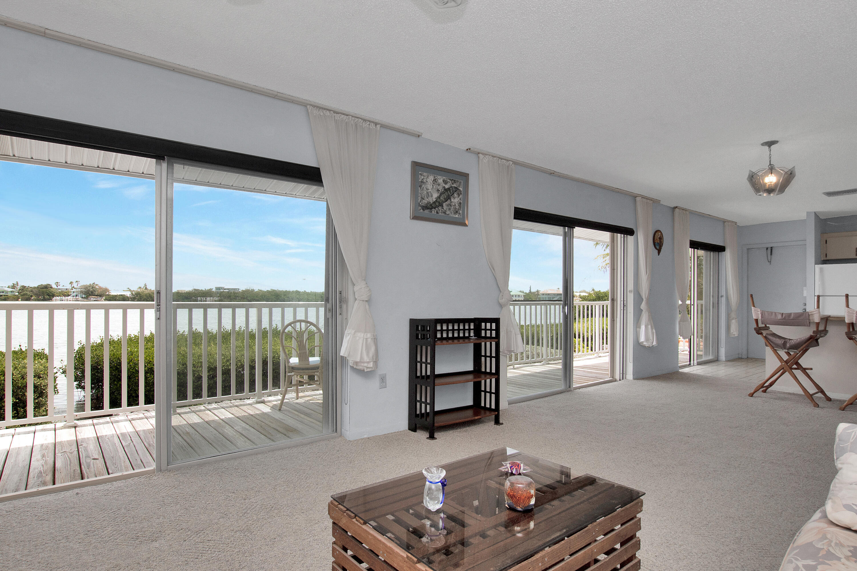 136 Brian Road Marathon, FL 33050 - Photo 8 of 19 a living room with furniture and a floor to ceiling window
