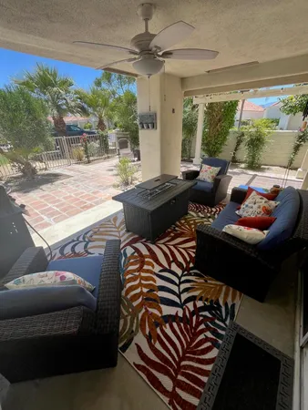 a living room with furniture and a floor to ceiling window