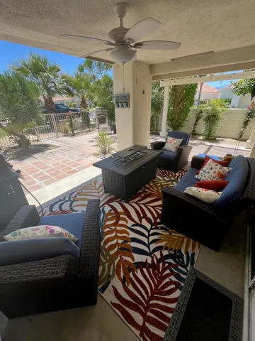 a living room with furniture and a floor to ceiling window