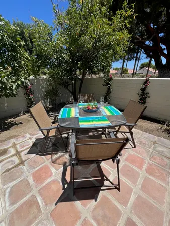 a view of a chairs and table in the patio