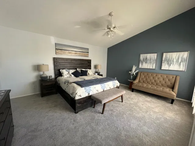 a bed room with a bed furniture and a tv