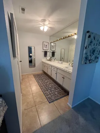 a bathroom with a sink a mirror and a shower