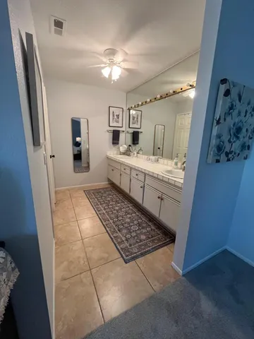 a bathroom with a sink a mirror and a shower
