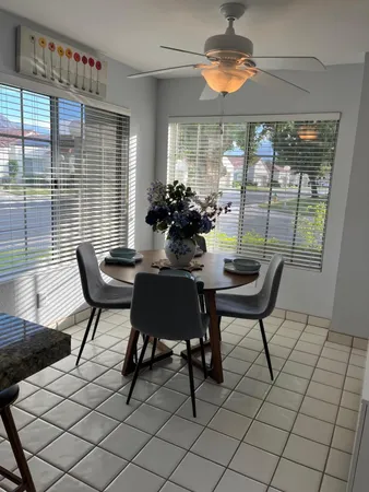 a dining room with furniture and window