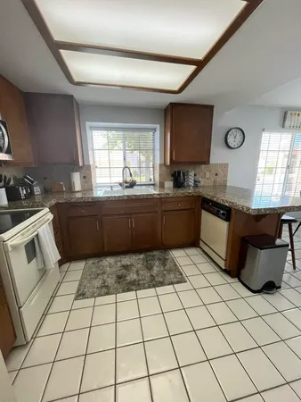 a kitchen with stainless steel appliances granite countertop a sink and a stove